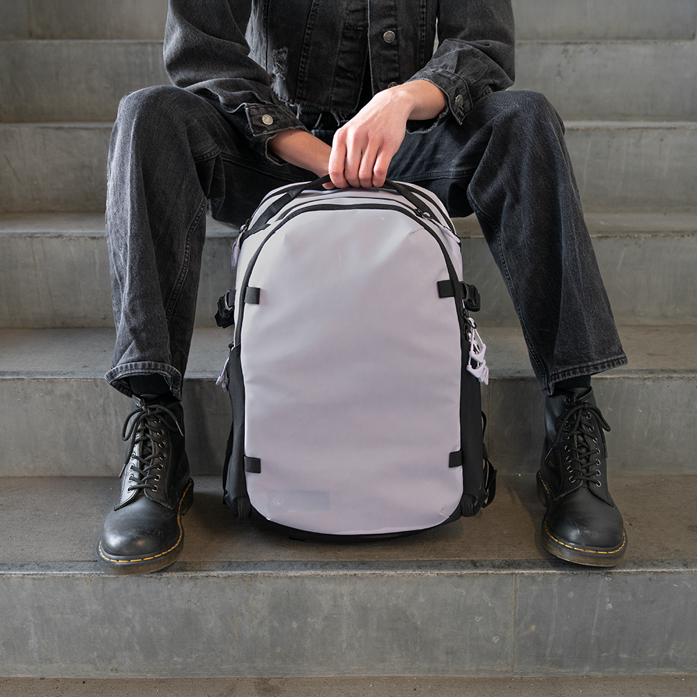 Woman sitting with Purple Stratus Photo 18L Backpack Front